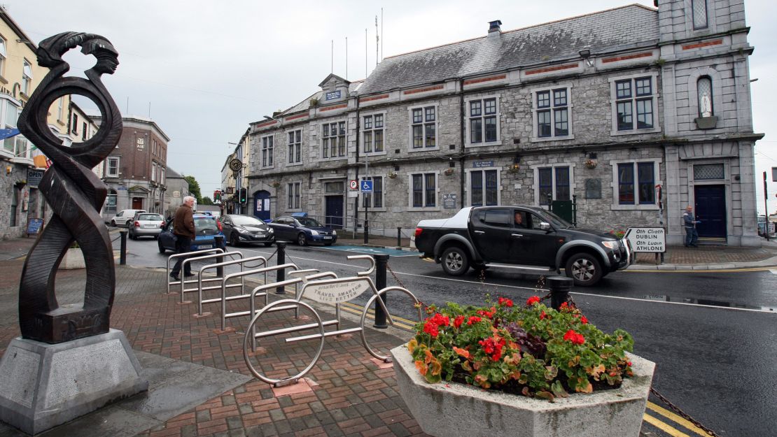 The plaque sits between two ground-floor windows (bottom right) at Tuam Town Hall. 