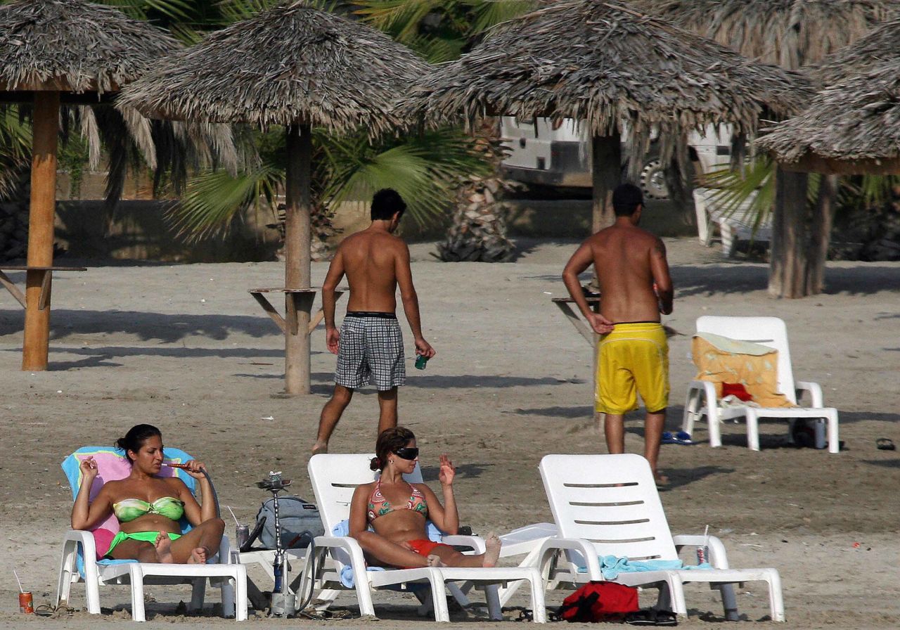 Sun-seekers enjoy a day at the beach in the Tyre.