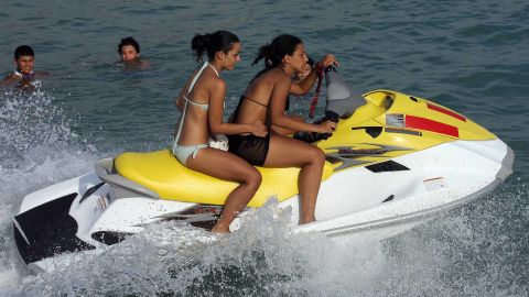 Lebanese girls ride a jet ski at the beach in the southern Lebanese city of Tyre.