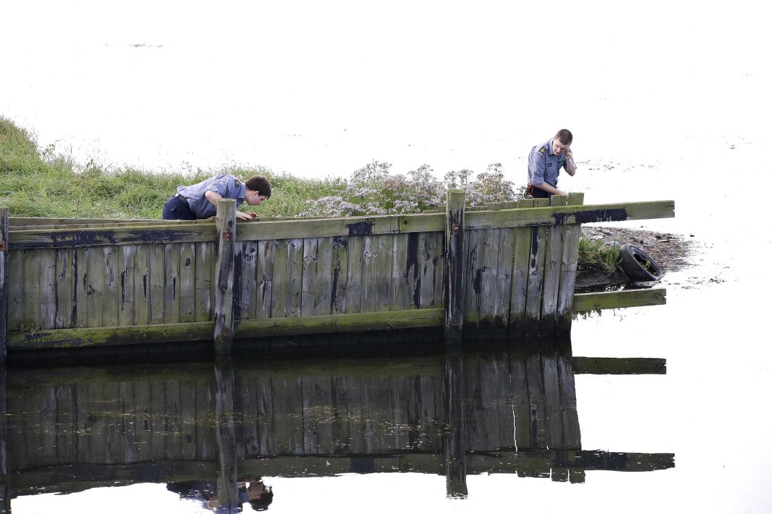 Officers search for missing body parts of Swedish journalist Kim Wall on August 23, close to the site where her torso was found two days earlier.