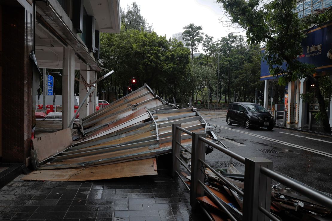 Typhoon Hato leaves a wooden wall collapsed Wednesday on a street in Hong Kong.