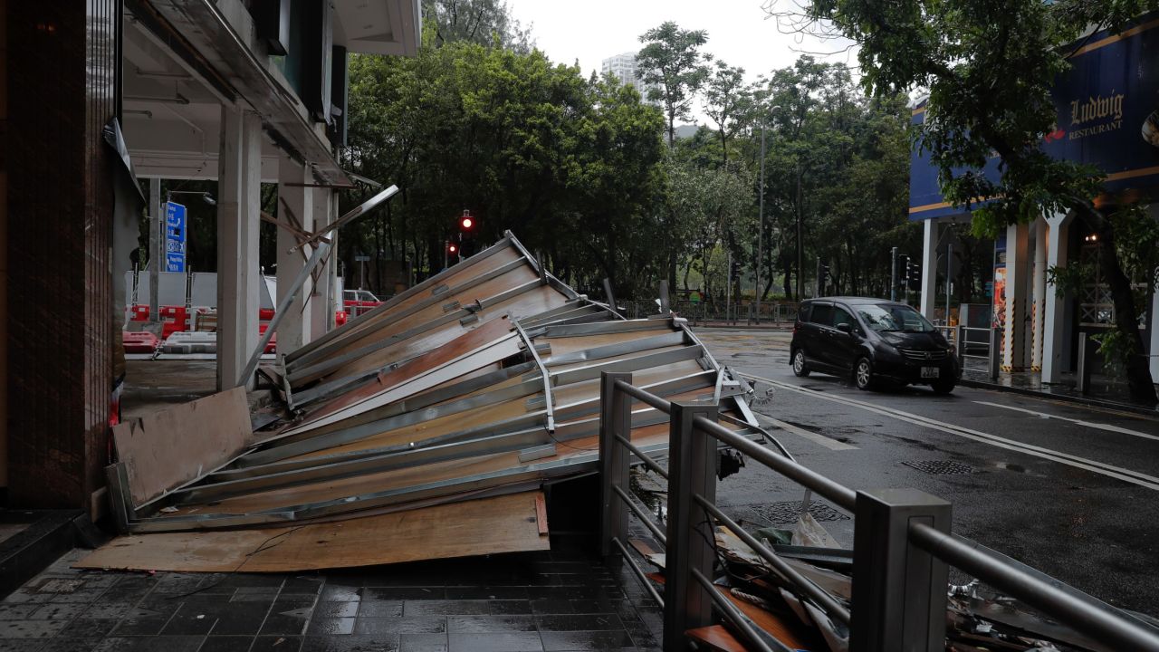 Typhoon Hato leaves a wooden wall collapsed Wednesday on a street in Hong Kong.