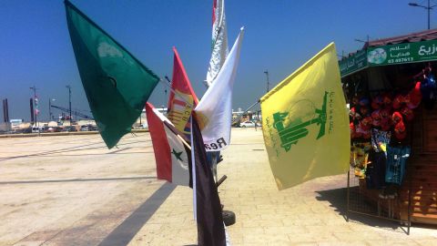The yellow and green flag of political party and militant group Hezbollah (right) for sale at a stall in Tyre alongside those of soccer clubs FC Barcelona and Real Madrid.