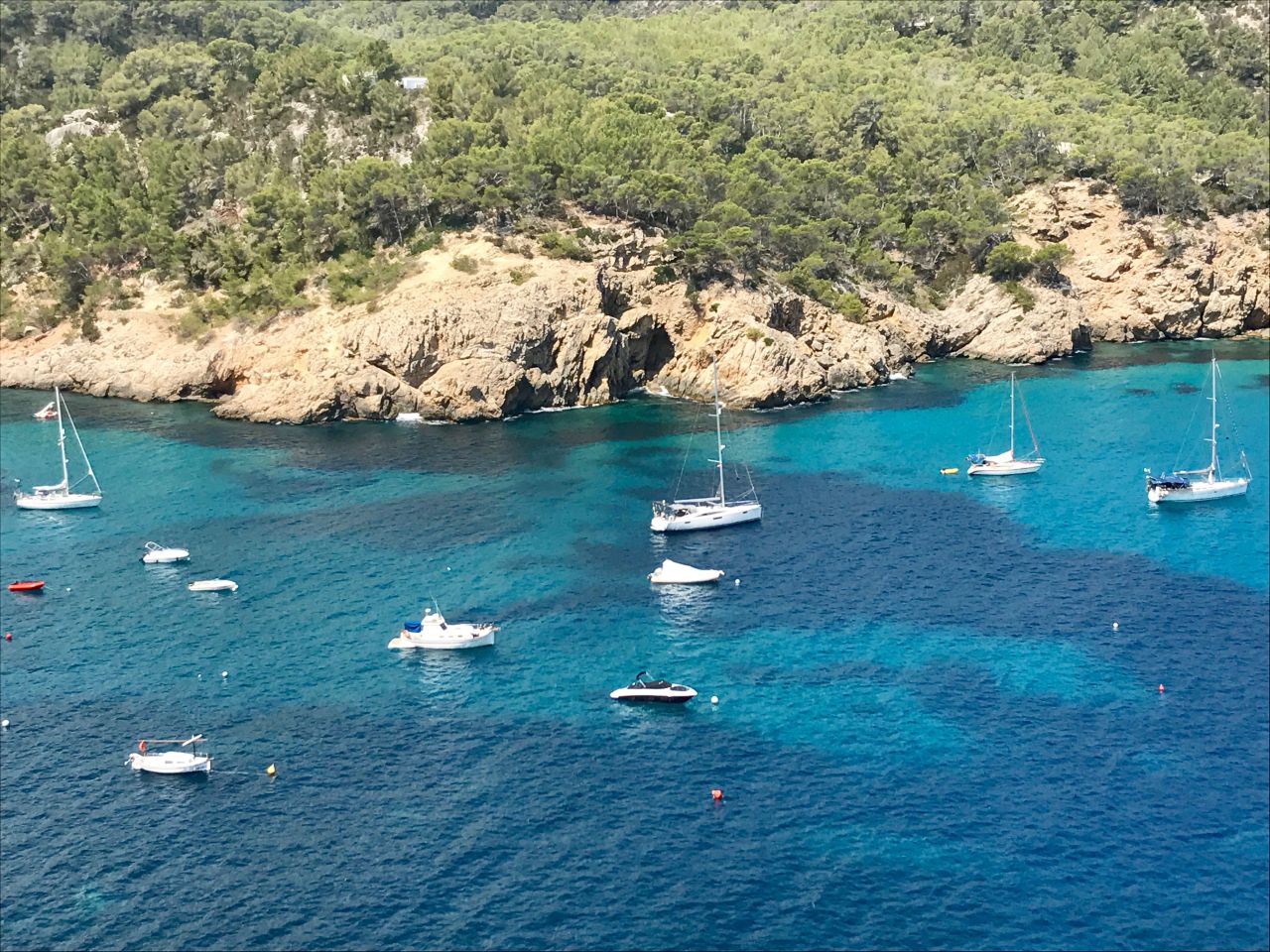 "Boomerang" is pictured anchored in the middle of Cala San Miguel in Ibiza, the kind of idyllic setting they envisaged when they bought the boat.