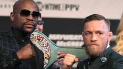 Boxer Floyd Mayweather Jr. (L) and MMA figher Connor Mcgregor pose during a media press conference August 23, 2017 at the MGM Grand in Las Vegas, Nevada. 
Mayweather, the 40-year-old undefeated former welterweight boxing champion, has been lured out of retirement to face McGregor, a star of mixed martial arts' Ultimate Fighting Championship. The two men meet in a 12-round contest under boxing rules on August 26th that is tipped to become the richest fight in history.
 / AFP PHOTO / John Gurzinski        (Photo credit should read JOHN GURZINSKI/AFP/Getty Images)