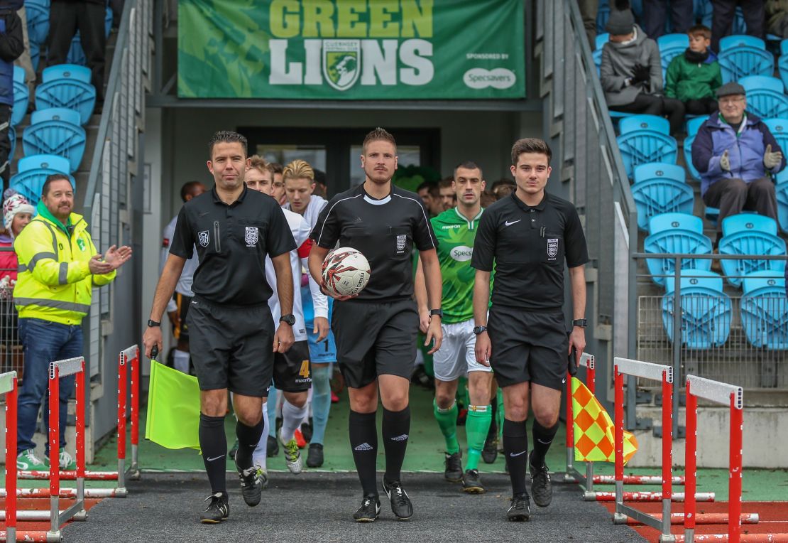 Atkin (center) will work as a fourth official in Football League games this season.