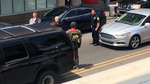 Police gather near the scene of a hostage situation Thursday at a Charleston restaurant.