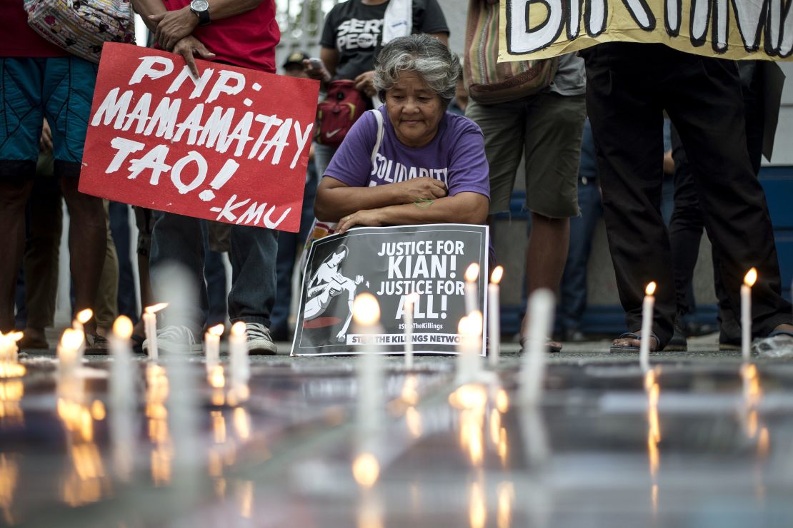 An activist holds a poster against extra-judicial killings during a protest in Manila on August 23, 2017. 