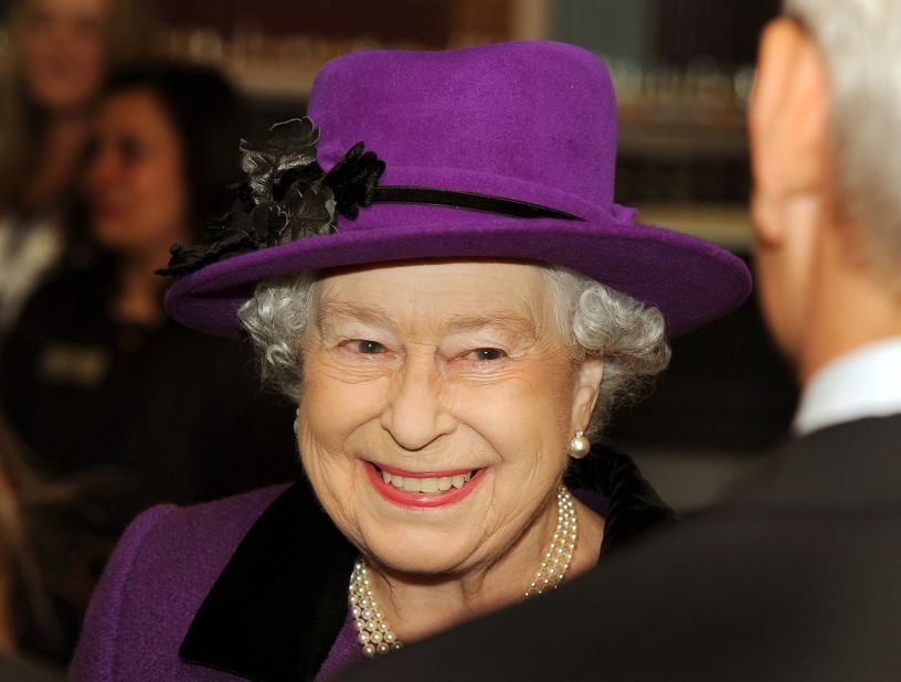 Queen Elizabeth II in a purple dress.
