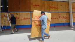 James Redford carries a sheet of plywood as he helps board up windows in preparation for Hurricane Harvey, Thursday, Aug. 24, 2017, in Corpus Christi, Texas. Two counties have ordered mandatory evacuations as Hurricane Harvey gathers strength as it drifts toward the Texas Gulf Coast.   (AP Photo/Eric Gay)
