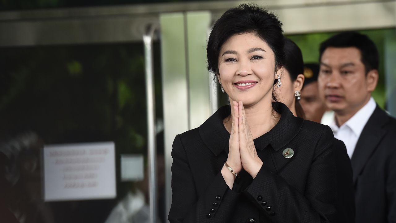 Yingluck Shinawatra greets supporters as she leaves the Supreme Court on July 21.