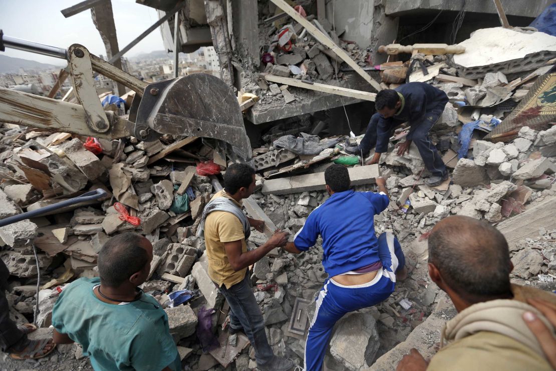 Yemenis search under the rubble of a house destroyed in an air strike in a residential area of the capital Sanaa on August 25, 2017.