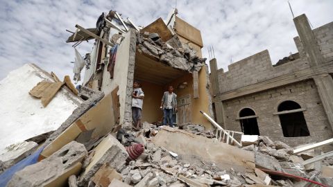 Yemenis stand in the rubble of a house destroyed in an airstrike in the residential Faj Attan district of the capital, Sanaa, on August 25, 2017.