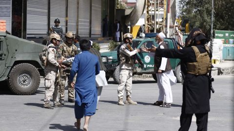 Afghan security officials take positions Friday near the Kabul mosque after the attack.