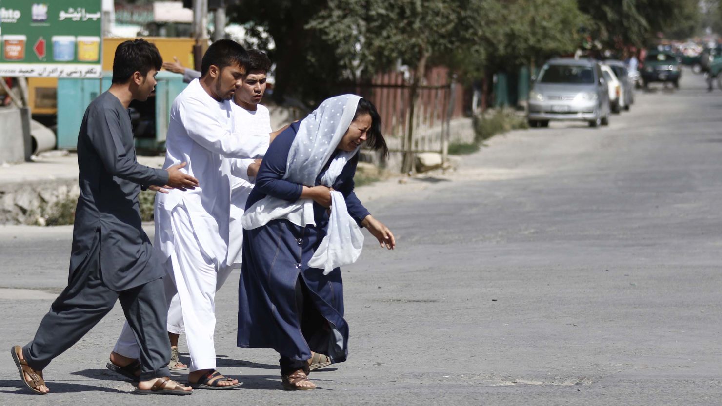 Afghans flee the site of an attack on a Shiite Muslim mosque in Kabul during Friday prayers.