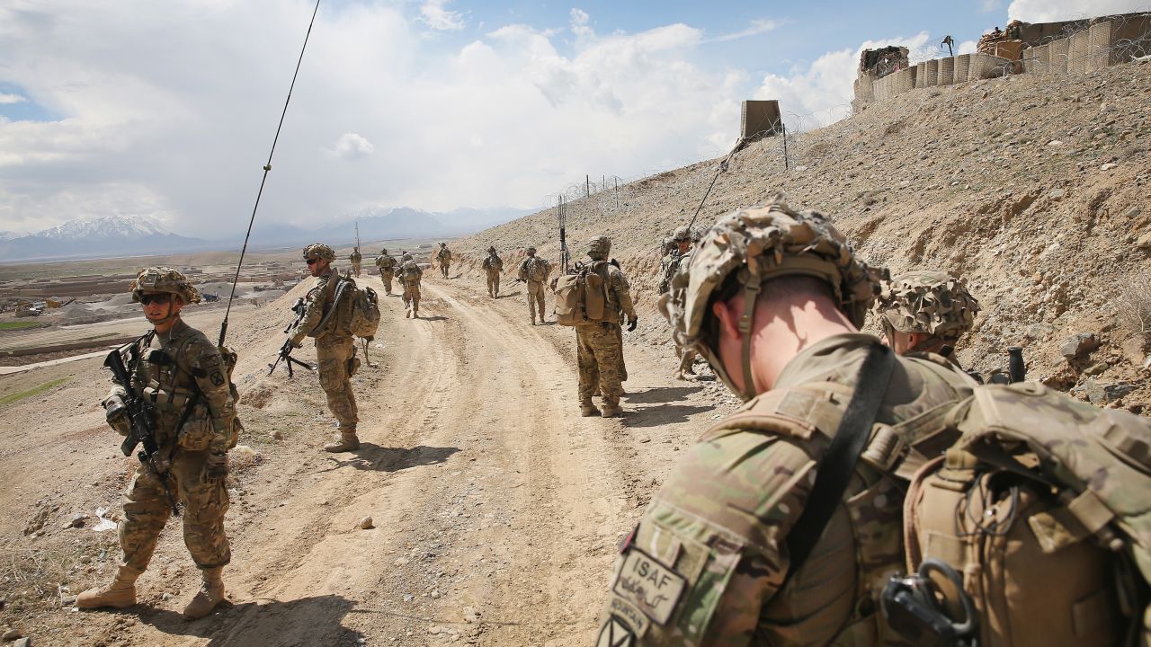 PUL-E ALAM, AFGHANISTAN - MARCH 29:  Soldiers with the U.S. Army's 2nd Battalion 87th Infantry Regiment, 3rd Brigade Combat Team, 10th Mountain Division patrol on the edge of a village outside of Forward Operating Base (FOB) Shank on March 29, 2014 near Pul-e Alam, Afghanistan. The primary mission of soldiers with the 10th Mountain Division stationed at FOB Shank is to advise and assist Afghan National Security Forces in the region. The soldiers continue to patrol outside the FOB in an effort to decrease rocket attacks on the FOB from the nearby villages.  Security is at a heightened state throughout Afghanistan as the nation prepares for the April 5th presidential election.  (Photo by Scott Olson/Getty Images)