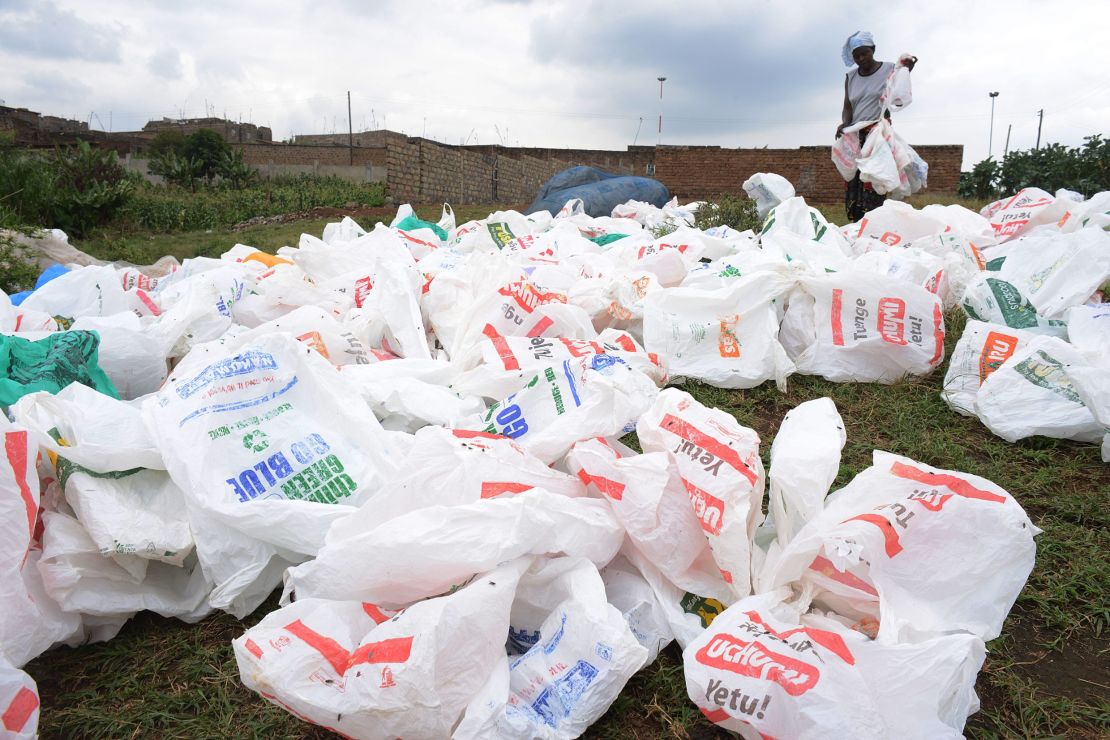 A woman sorts plastic bags after washing them for re-use in a river in Nairobi, Kenya.