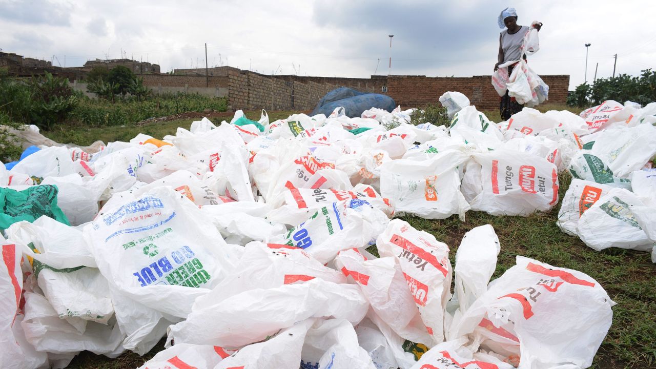 A woman sort out plastic bags after washing them for re-use at the shores of a river in Nairobi, Kenya.