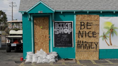 A sign reading "Be Nice Harvey" was left behind on a boarded-up business  in Port Aransas.