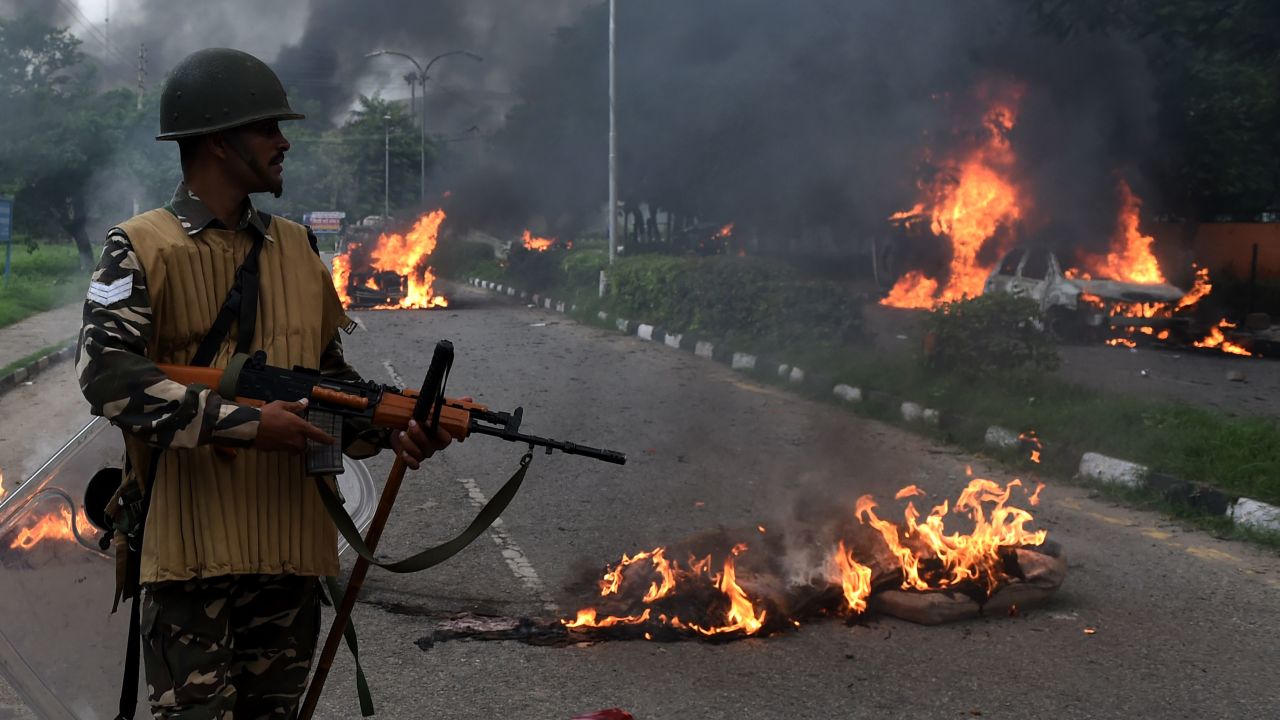 An Indian soldier stands guard Friday in Panchkula, where the guru's trial was held.