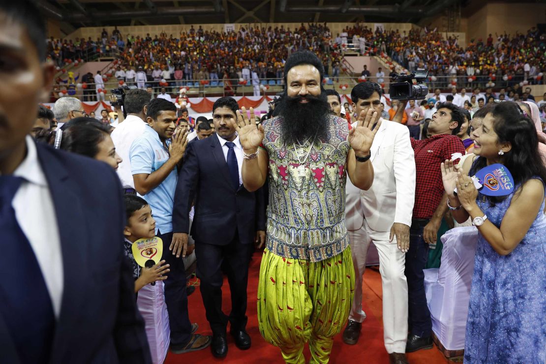  Gurmeet Ram Rahim Singh, center, greets followers as he arrives for a press conference in New Delhi, India, in October 2016. 