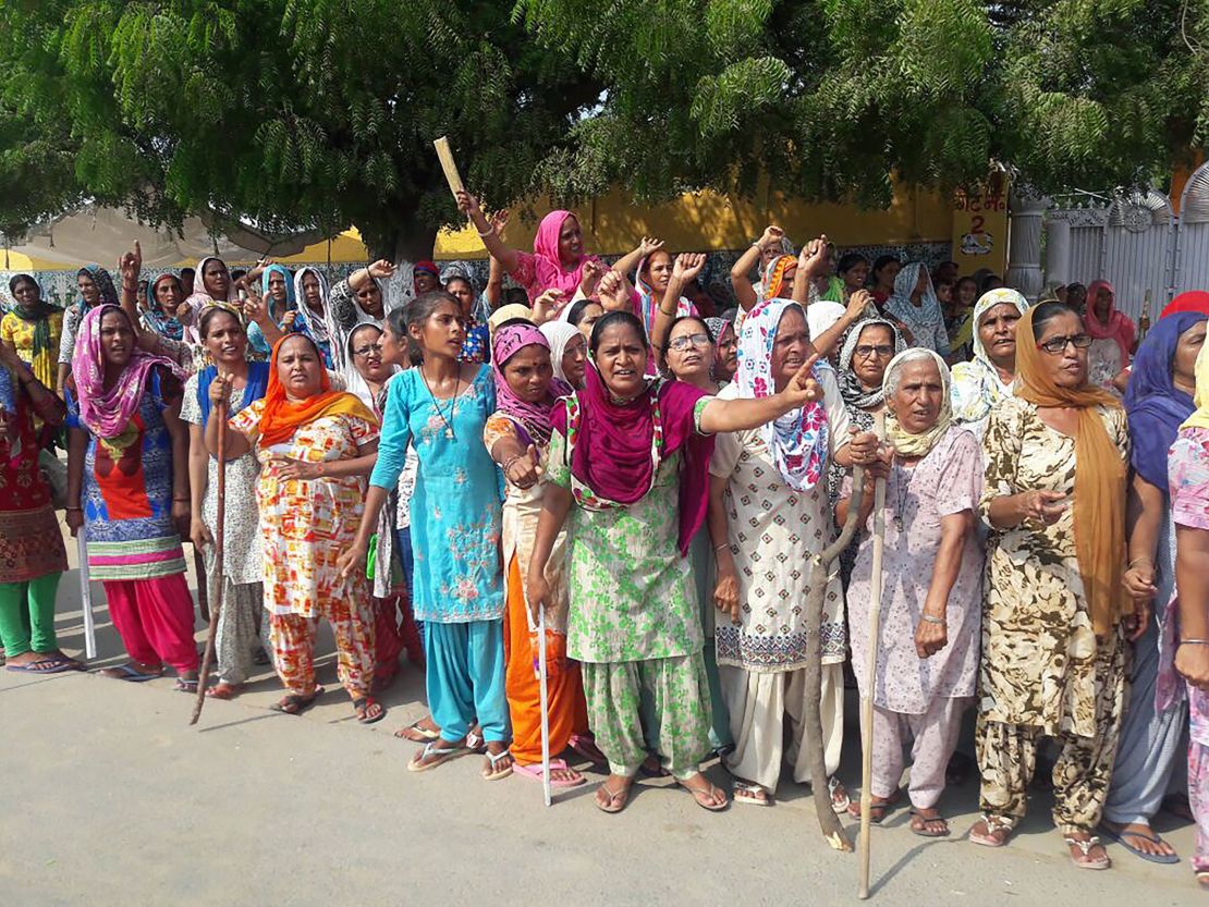 The guru's supporters gather on the roadside in Sirsa on Thursday before the verdict in the rape case. 
