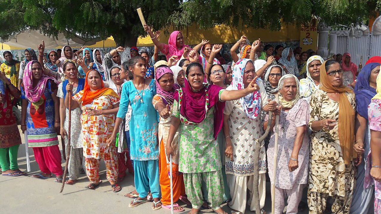 The guru's supporters gather on the roadside in Sirsa on Thursday before the verdict in the rape case. 
