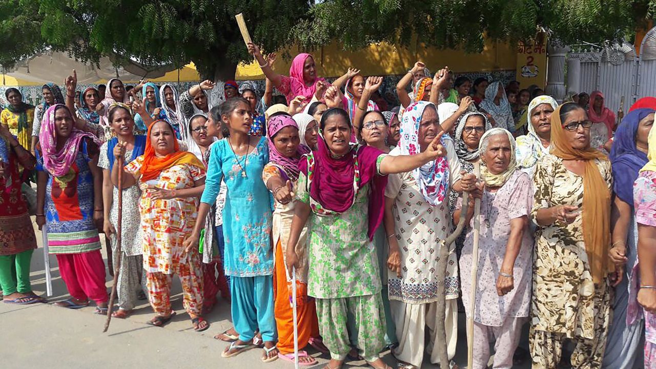 The guru's supporters gather on the roadside in Sirsa on Thursday before the verdict in the rape case.
