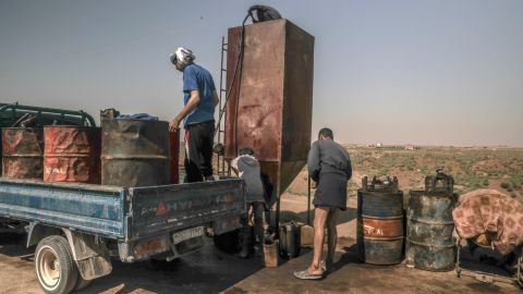 Local residents refuel at an improvised gas station in a liberated area in west Raqqa on Friday.