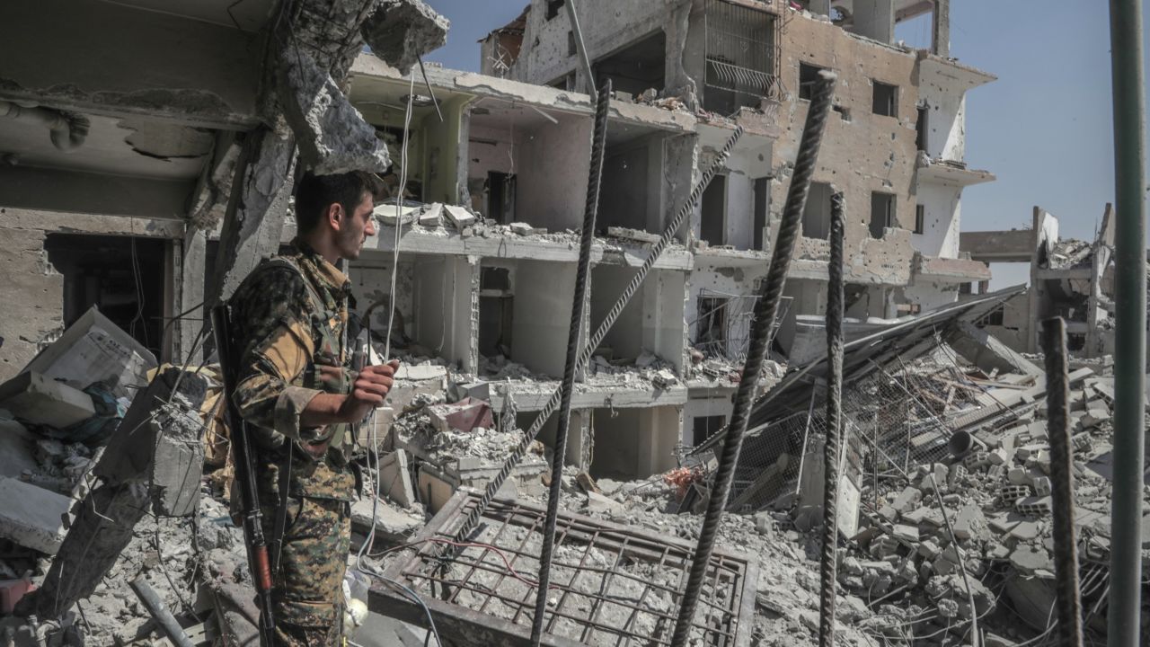 SDF forces painstakingly clear buildings from ISIS-planted mines, often facing sniper fire.