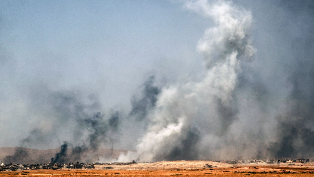 Smoke billows as Iraqi forces, backed by Popular Mobilization Units, advance inside the town of Tal Afar on Friday, August 25.