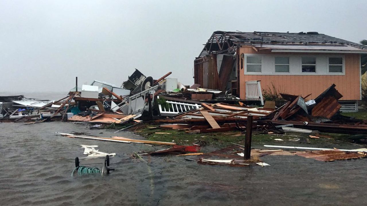 A damaged home sits amid a flood on Saturday after Hurricane Harvey slammed Rockport, Texas.