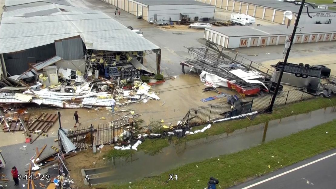 Buildings in Houston are damaged and trucks are flipped over after Harvey blew through.