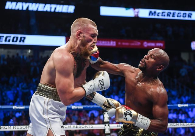 Floyd Mayweather Jr. lands a right hand against Conor McGregor during their boxing match in Las Vegas on Saturday, August 26. Mayweather <a href="index.php?page=&url=http%3A%2F%2Fwww.cnn.com%2F2017%2F08%2F27%2Fsport%2Fmayweather-vs-mcgregor-fight%2Findex.html" target="_blank">stopped McGregor in the 10th round,</a> collecting his 50th victory in what he said will be the last fight of his undefeated pro career. It was the first pro boxing match for McGregor, a mixed martial artist who is the UFC's lightweight champion.