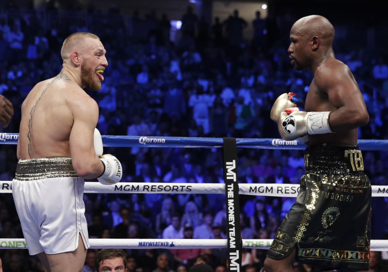 McGregor sticks his tongue out at Mayweather during an early exchange.