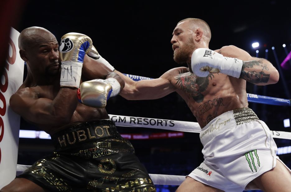 McGregor swarms Mayweather at the start of the fight.