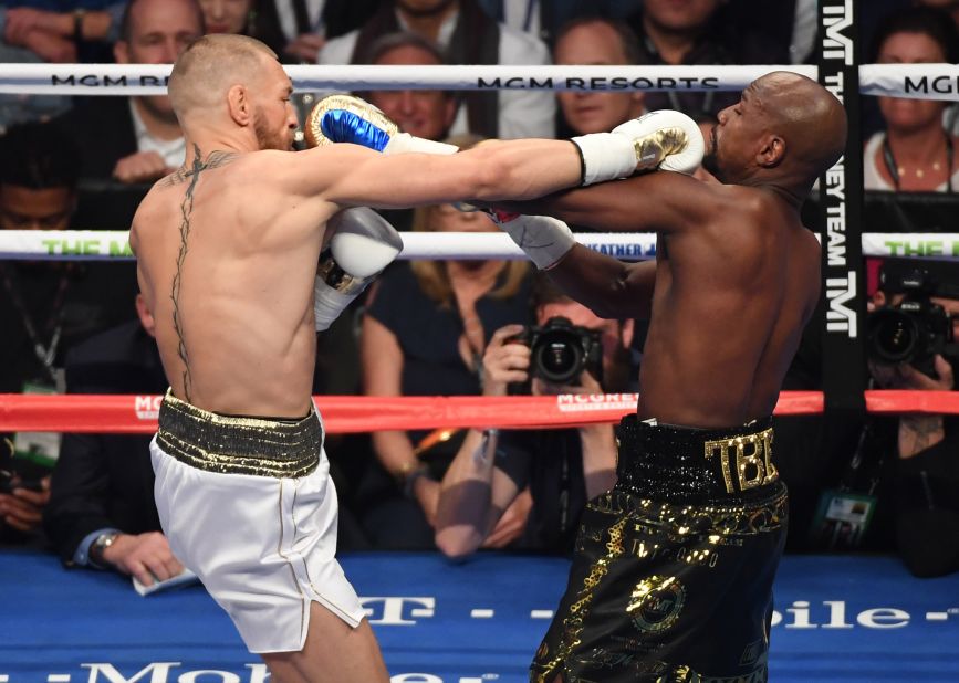 The two fighters trade punches in the middle of the fight.