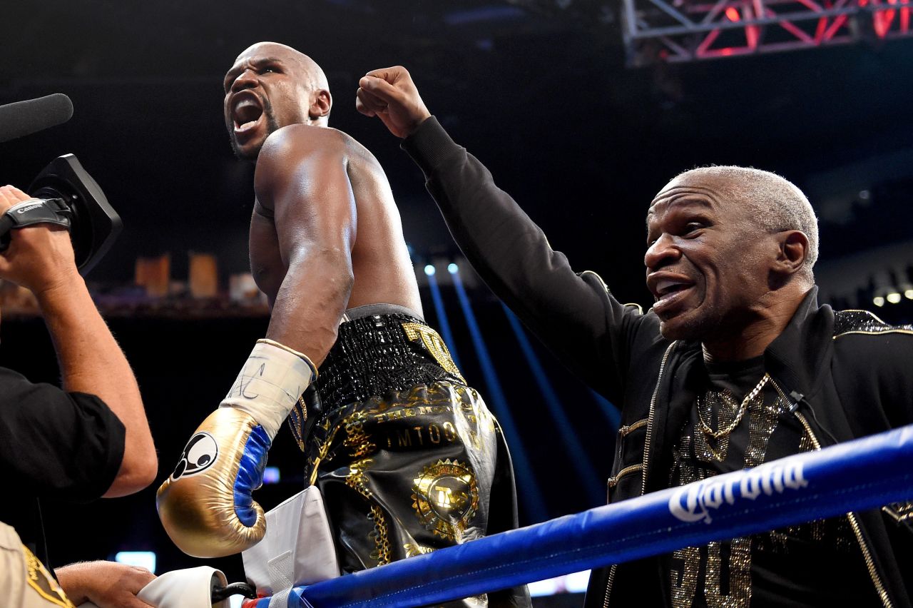 Mayweather and his father celebrate the victory.