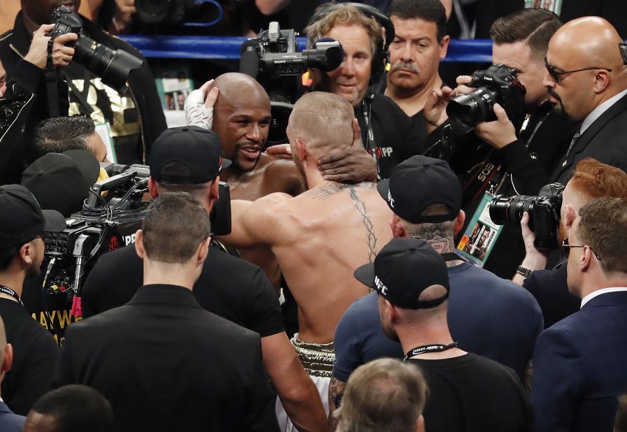 The two combatants embrace after the fight.