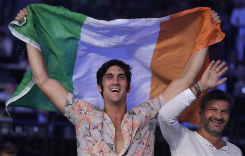 A fan waves an Irish flag before the start of the fight.