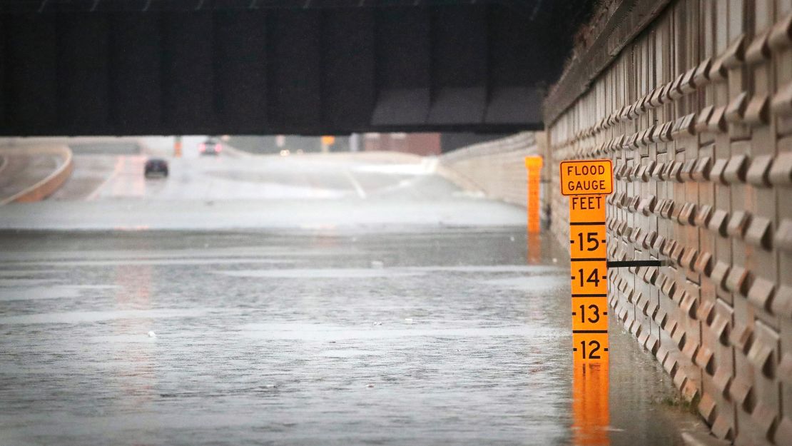 A flood guage in an underpass warns of the water's depth on Interstate 10 in Houston on Sunday.