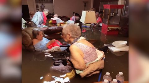 Nursing home residents in Dickinson, Texas, wait for first responders in a flooded room.