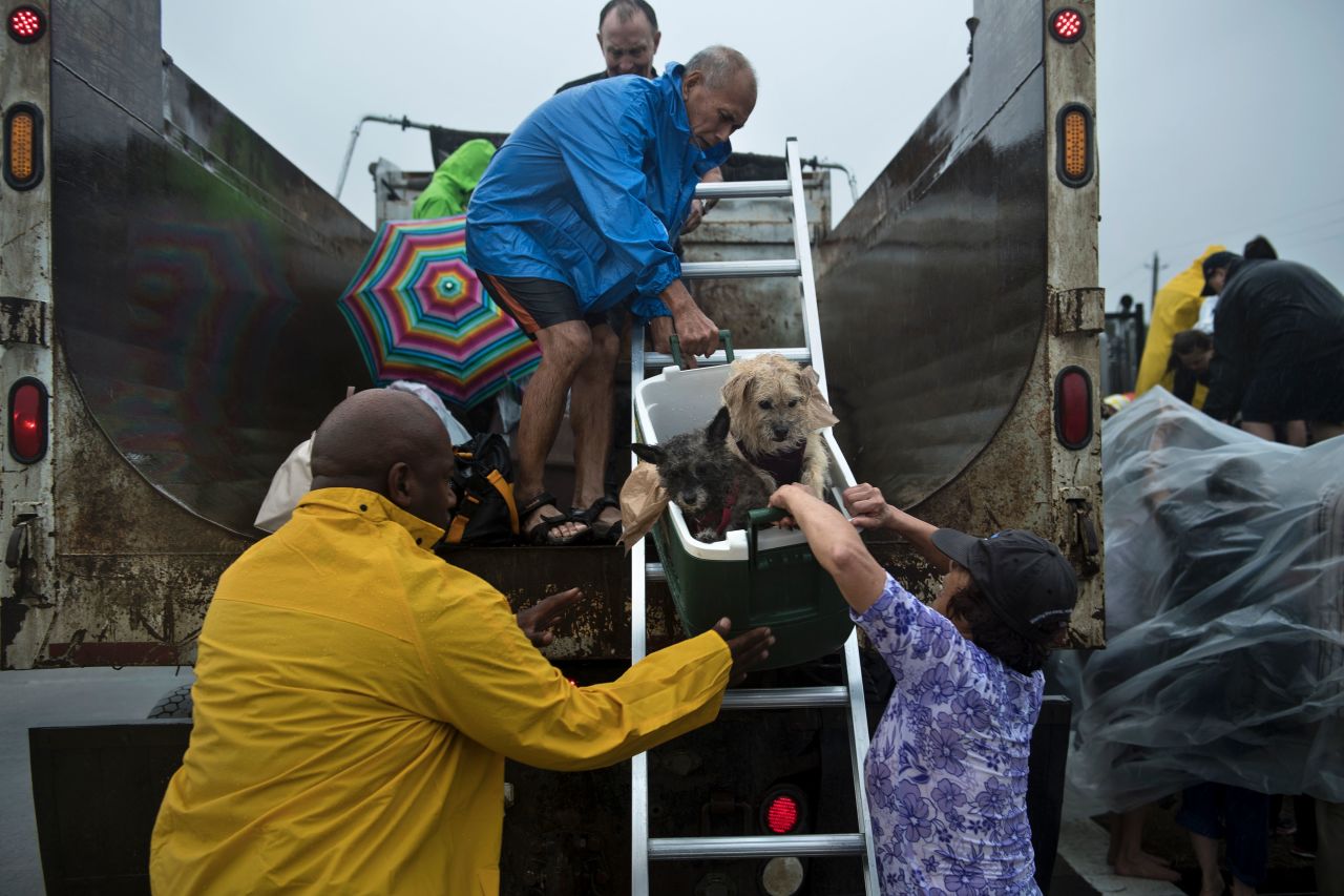 Evacuees are loaded onto a truck in Houston.