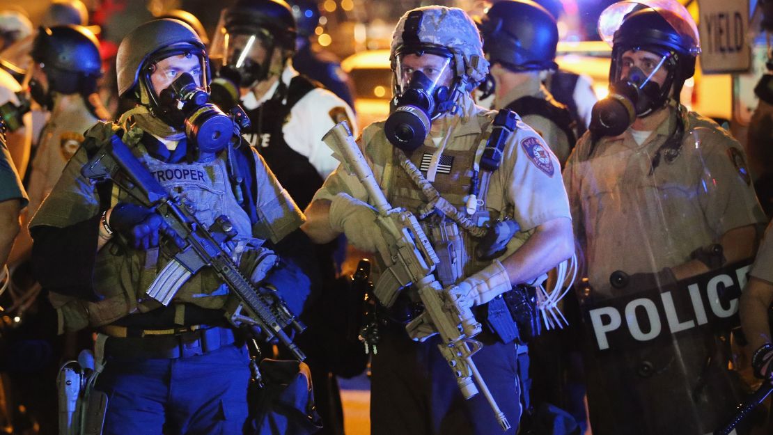 Police attempt to control demonstrators protesting the killing of teenager Michael Brown on August 18, 2014 in Ferguson, Missouri. 