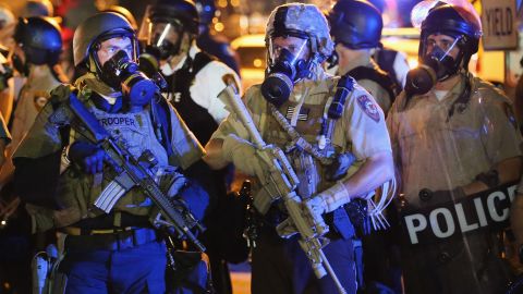 Police attempt to control demonstrators protesting the killing of teenager Michael Brown on August 18, 2014 in Ferguson, Missouri. 