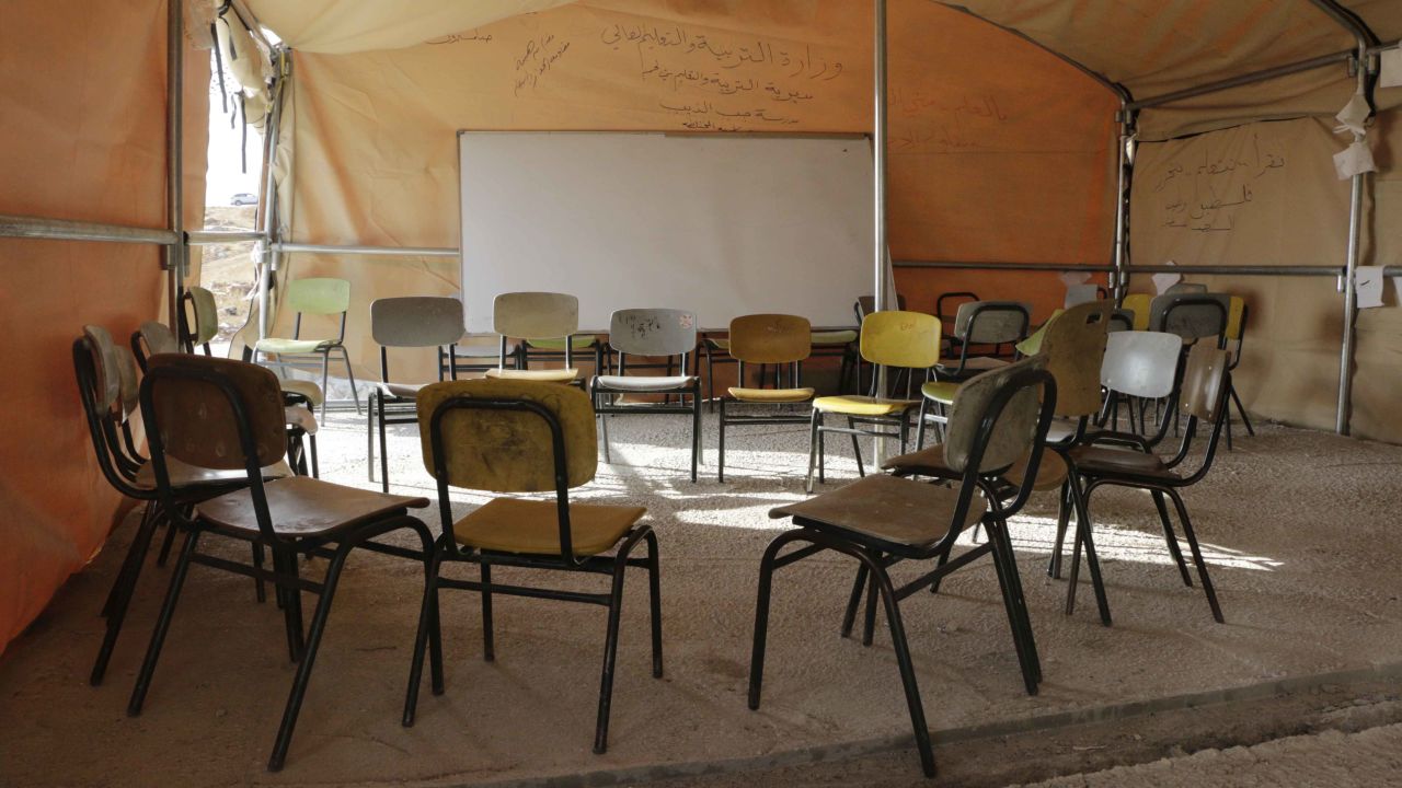 The makeshift tent-school in Jub-El-Thib has chairs but no tables.