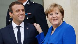 German Chancellor Angela Merkel (R) and French President Emmanuel Macron leave the Elysee Palace in Paris on July 13, 2017, after an annual Franco-German Summit.  / AFP PHOTO / Patrick KOVARIK        (Photo credit should read PATRICK KOVARIK/AFP/Getty Images)