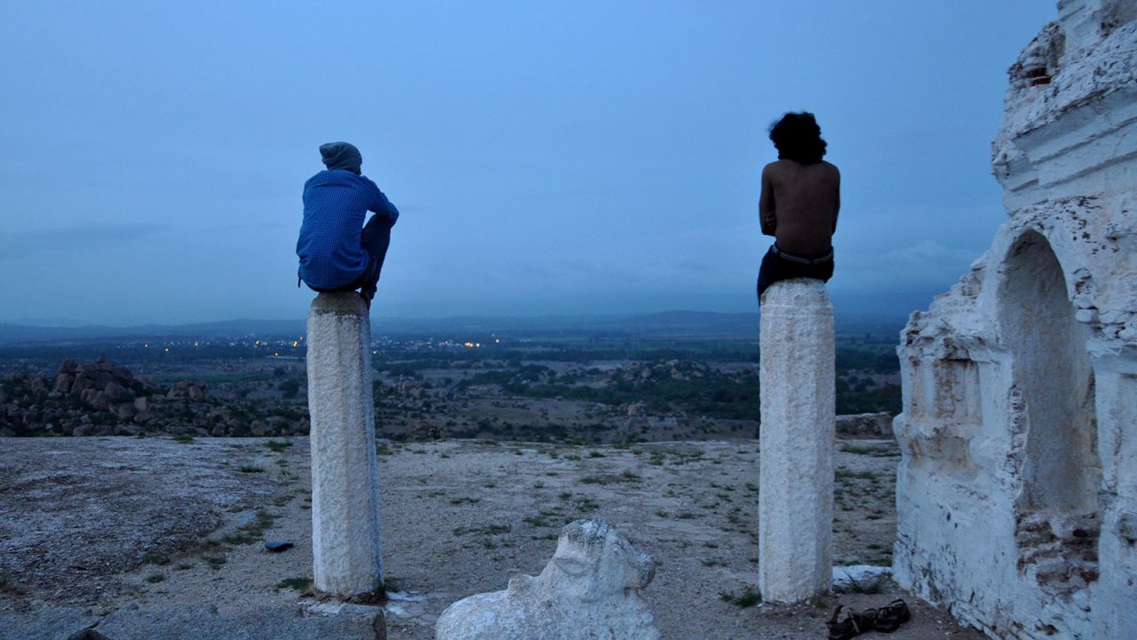 <strong>Dawn</strong><strong>:</strong> Two hikers sit atop what remains of the Veerabhadra Temple at the top of Matanga Hill, as they settle in to wait for the sunrise.