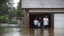 People wait to be rescued from their flooded home in Houston on August 28.