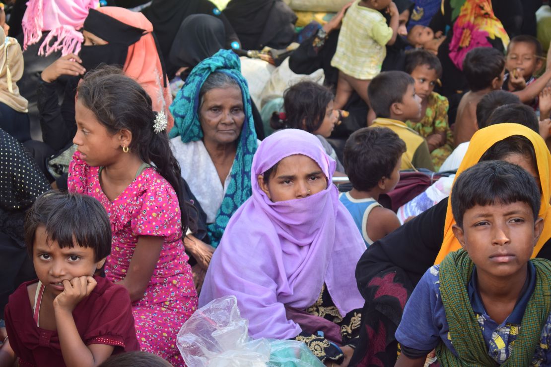 Rohingya woman Sayra Begum, wearing purple, sits with her relatives at a shelter in Cox's Bazar. 